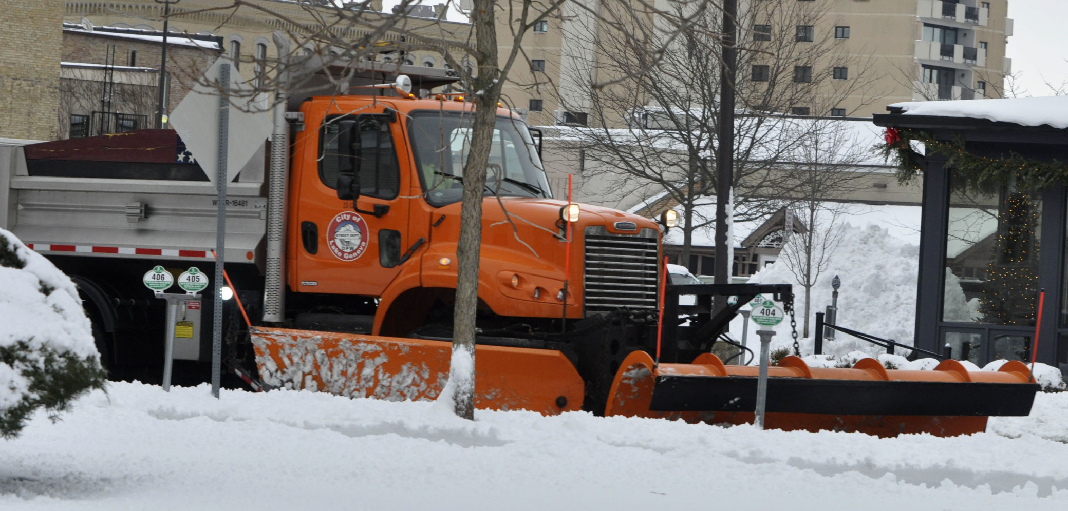 A city plow truck travels down Geneva Street, as city crews remove snow from downtown streets